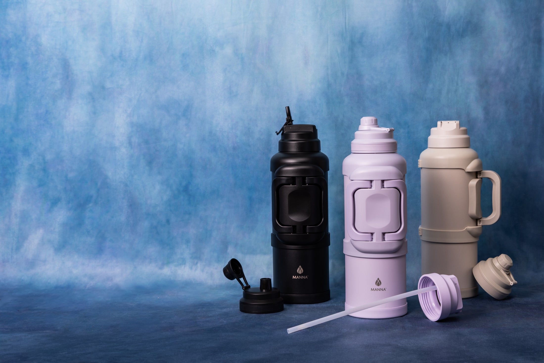 Manna Titan bottles in black, lilac and warm grey